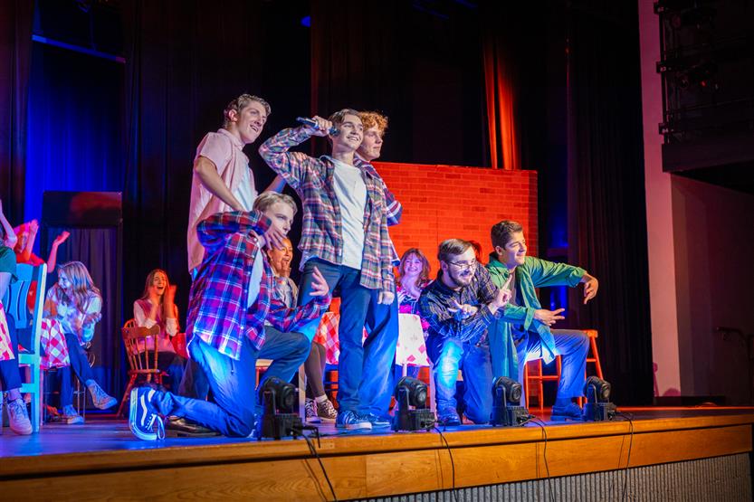 Students perform onstage